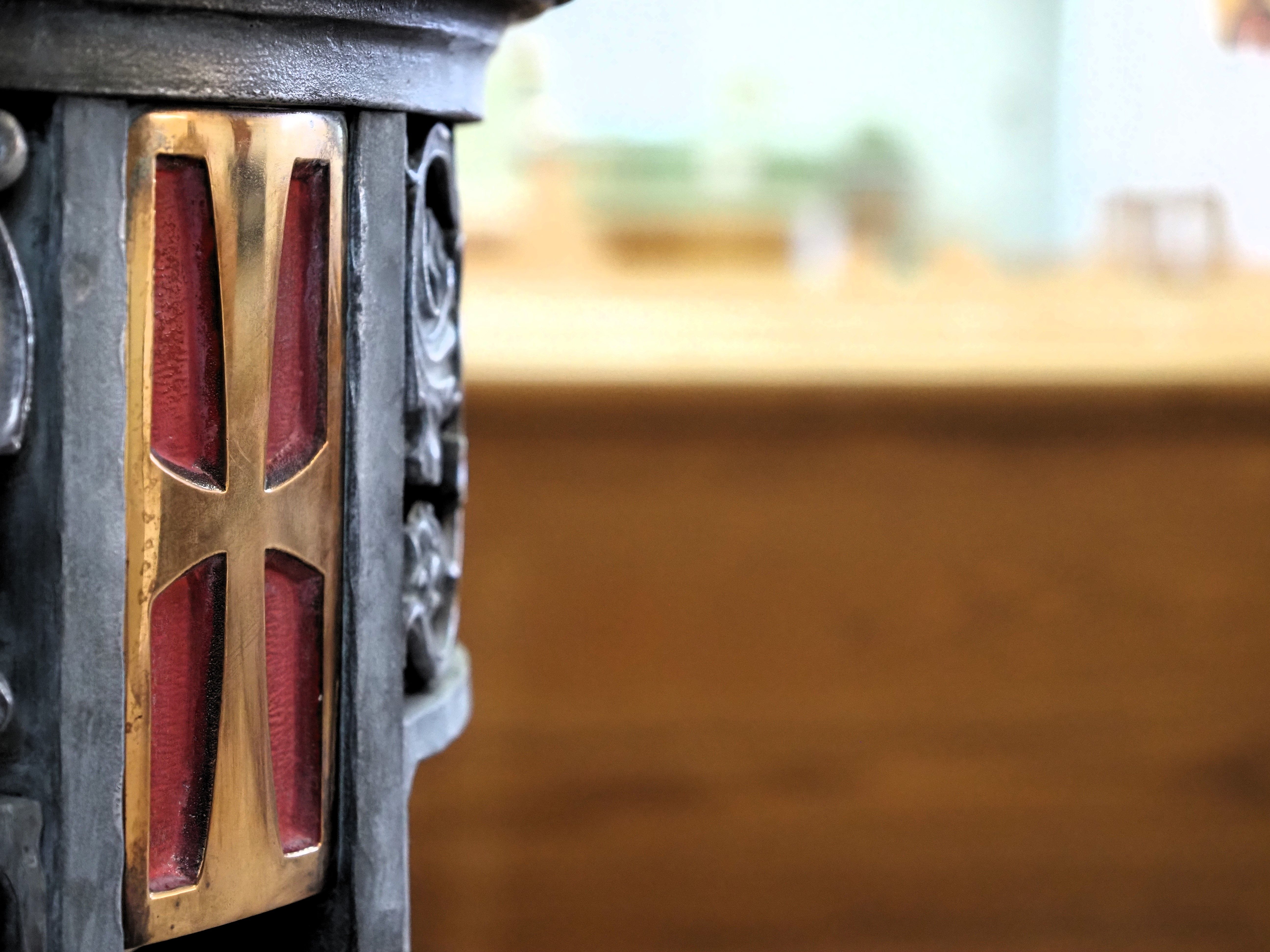 Brass cross on the baptismal font