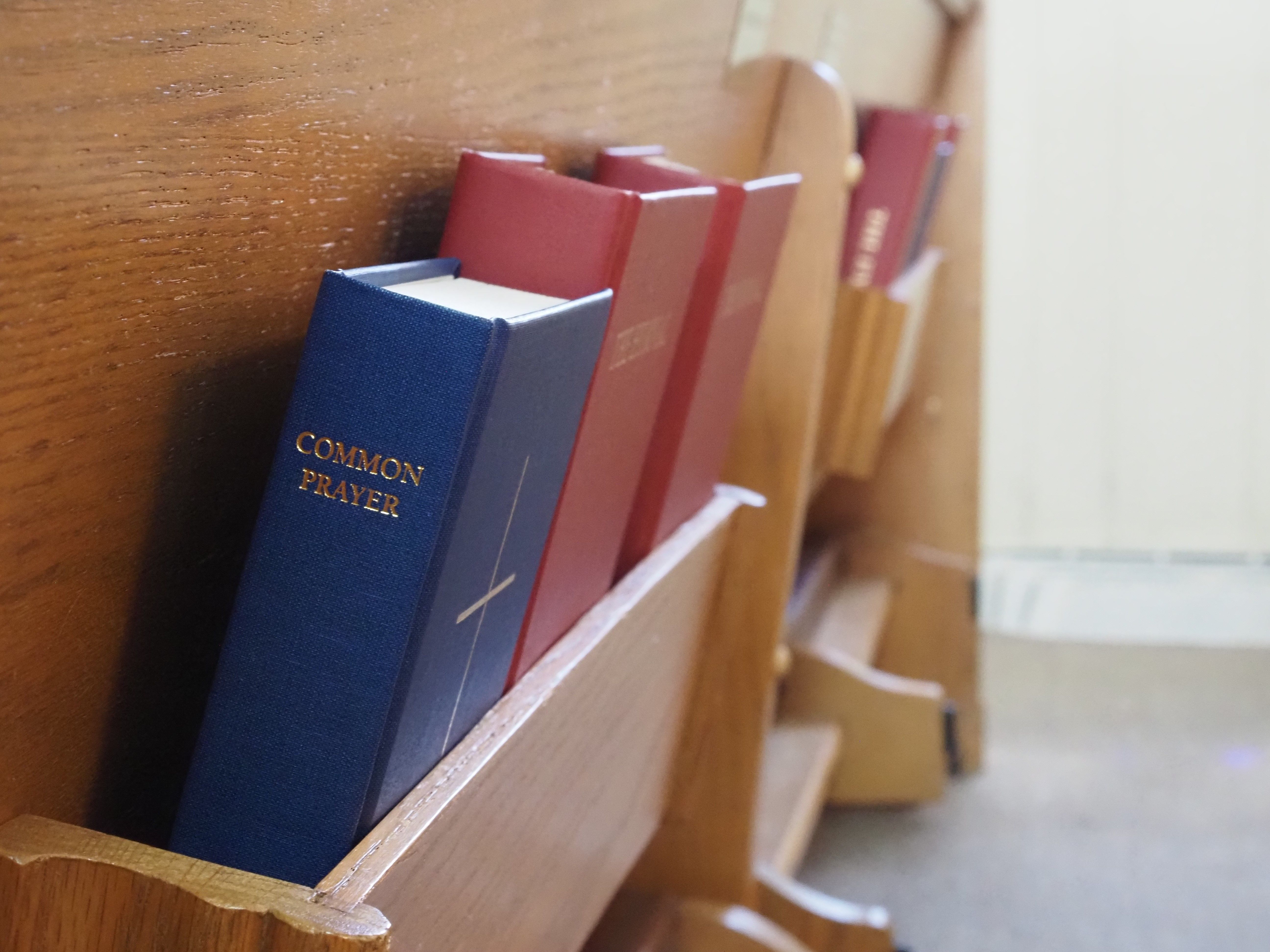 Books of Common Prayer in a pew rack