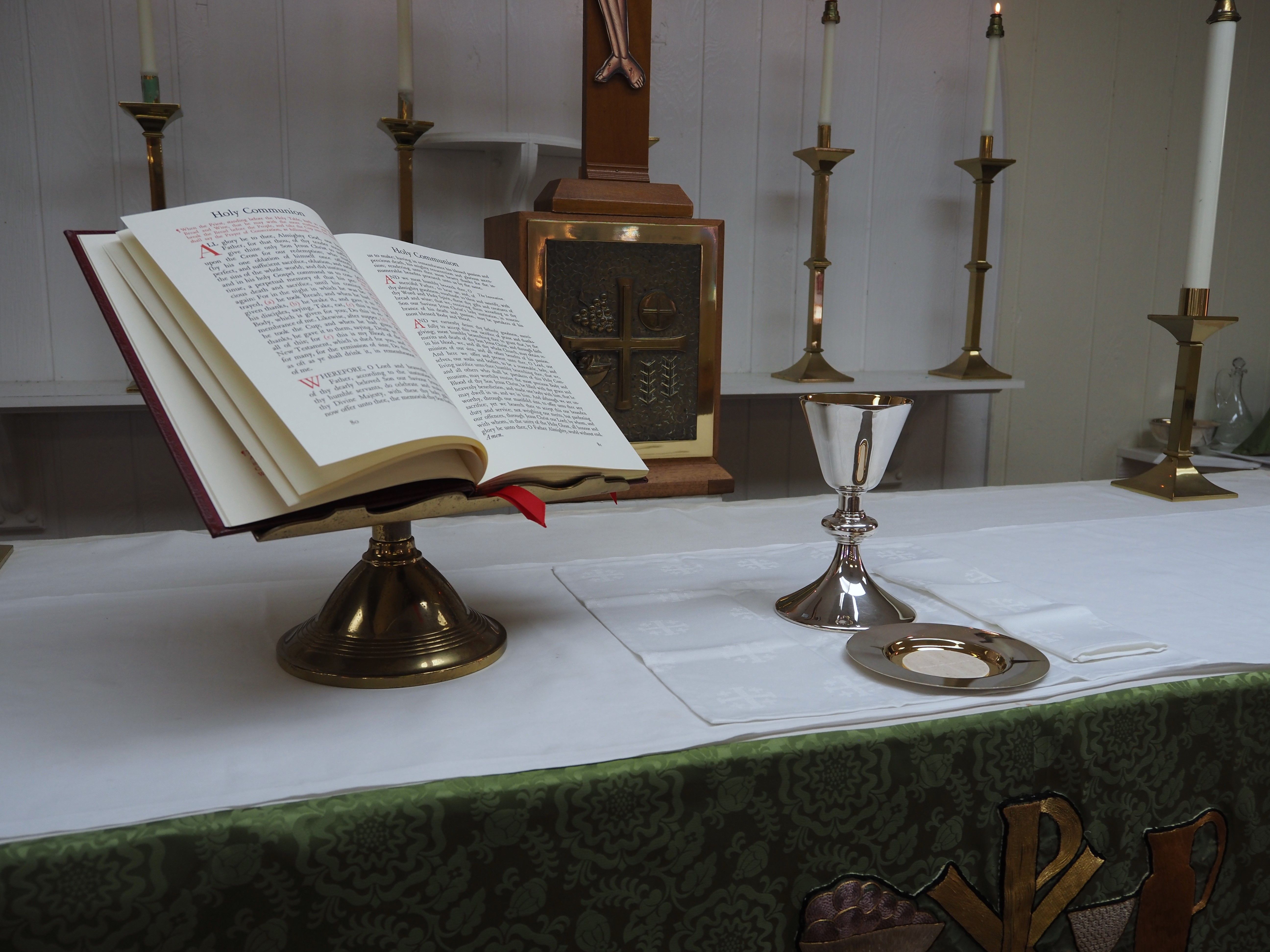 Altar with an open missal, chalice, and candles